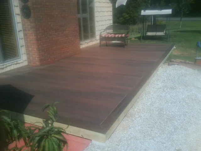 Freshly stained wood deck built against a brick home in Alpine
